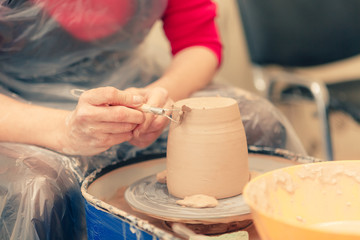 The process of creating a ceramic cup on a potter's wheel in art studio