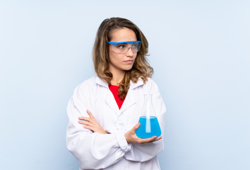 Young blonde woman with a scientific test tube and looking lateral