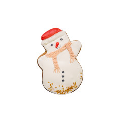 Christmas gingerbread in the form of a snowman covered with white sweet icing. Homemade holiday pastries. Isolated on a white background