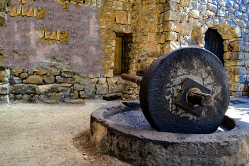 Old stones for squeezing olives oil, stone mill and mechanical press. © zilber42
