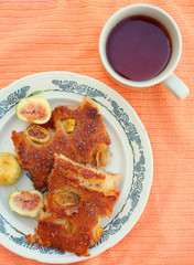 pancake with fig and cup of tea on the table