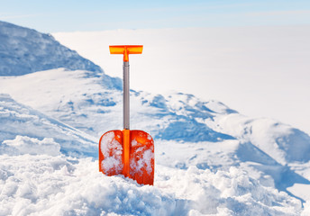 Shovel for  snow cleaning during snowfall or avalanche. Snow storm in winter time season. Tool for...