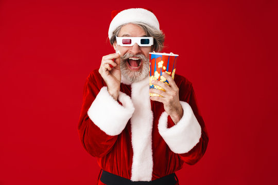 Image of old Santa Claus man in 3D glasses holding popcorn bucket