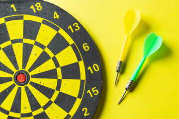 Target and darts for darts on a yellow background