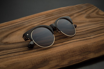Fototapeta na wymiar premium dark brown sunglasses on wooden background