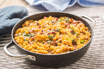 Baked pasta fusilli with smoked pork neck mozzarela cheese and othe ingredients
