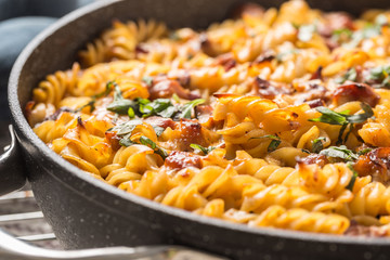 Baked pasta fusilli with smoked pork neck mozzarela cheese and othe ingredients