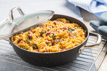 Baked pasta fusilli with smoked pork neck mozzarela cheese and othe ingredients