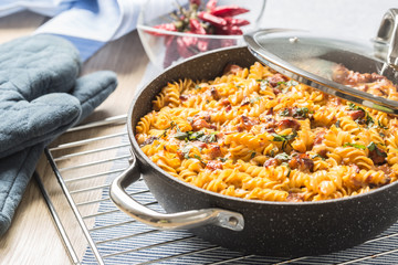 Baked pasta fusilli with smoked pork neck mozzarela cheese and othe ingredients