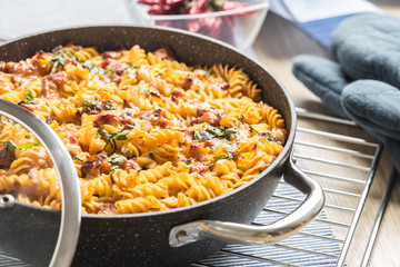 Baked pasta fusilli with smoked pork neck mozzarela cheese and othe ingredients