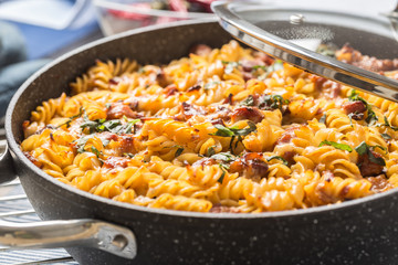 Baked pasta fusilli with smoked pork neck mozzarela cheese and othe ingredients