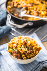 Baked pasta fusilli with smoked pork neck mozzarela cheese and othe ingredients