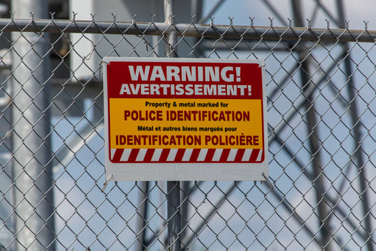 two languages French and English Warning Signage, property and metal marked for police identification, electrical substation, Quebec, Canada