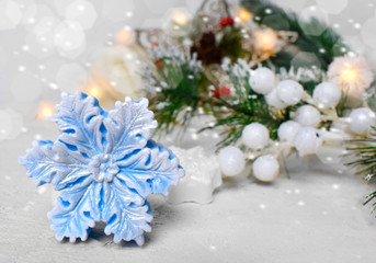 Christmas decoration over snowy festive background. Snowflake, fir tree on bokeh lights background. Copyspace.