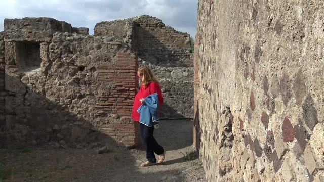 Italy, Pompeii, archaeological area, remains of the city buried by the eruption of ashes and rocks of Vesuvius in 79. Tourist turns in the ruins