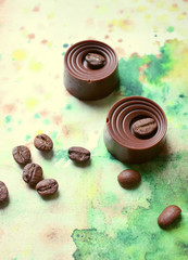 chocolates, coffee beans and chocolate with green background