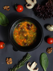 Culinary dishes made from natural products in a plastic bowl on the background with ingredients for cooking. Healthy food delivery concept. Top view.