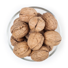 Walnuts in glass bowl isolated on white background with clipping path