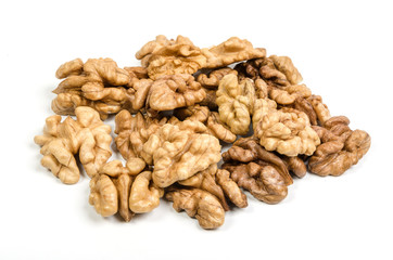 heap of walnut kernels on white