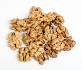 heap of walnut kernels on white