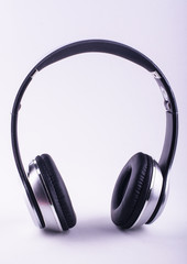 Fototapeta na wymiar Beautiful silver and black headphones on a white background.
