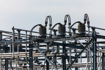 high voltage electrical substation tower top, close up on a closed electrical Isolator or...