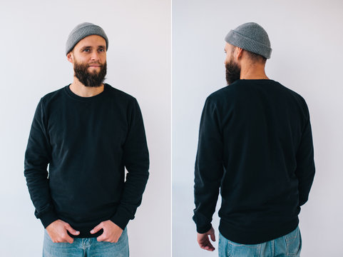 City Portrait Of Handsome Hipster Guy With Beard Wearing Black Blank Hoody Or Sweatshirt With Space For Your Logo Or Design. Front And Back View Mockup