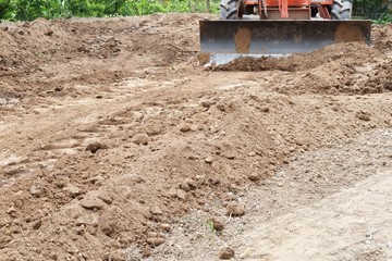tractor push clot soil after pour from truck