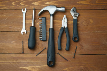 Composition of hand tools, screwdriver, hammer, pliers, top view
