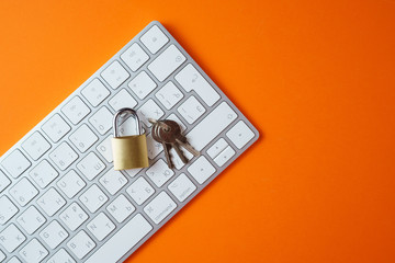 The idea of protecting information, the lock on the keyboard, on an orange background