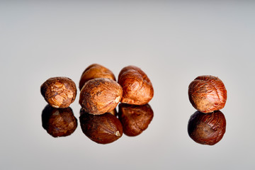 peeled hazelnuts on a mirror surface