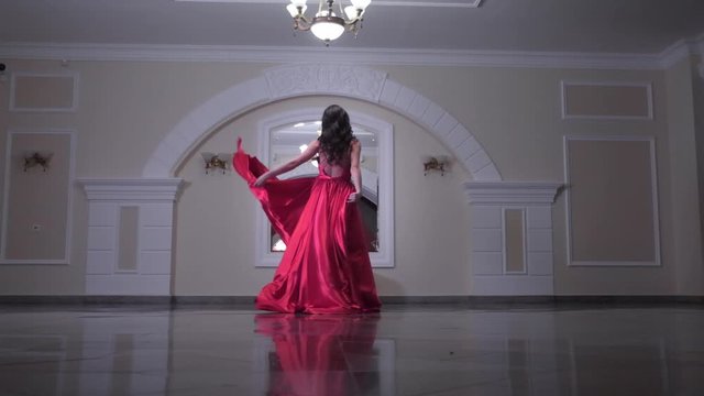 Beautiful woman in a red dress posing. Fashion and style concept.