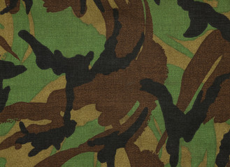 Fragment of camouflage fabric with army combat uniform. Closeup abstract top view drawing.