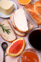 Slice of white bread with butter and a cup of black coffee. Food for breakfast