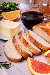 Sliced wheat bread surrounded by butter and orange pieces
