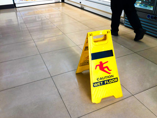 Yellow sign - caution. Wet floor is in the supermarket