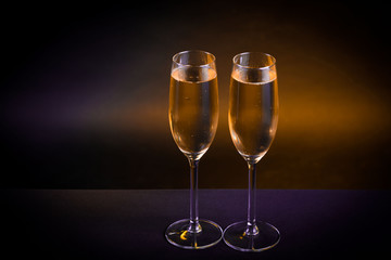 Drink. Two glasses white wine, dark background