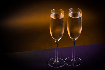 Drink. Two glasses white wine, dark background