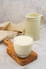 Jug and glass with milk on bright background isolated. Breakfast drink. Dairy.