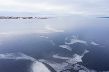 Winter landscape. The first thin ice on the big river. Shooting from a drone.