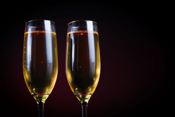 Drink. Two glasses white wine, dark background