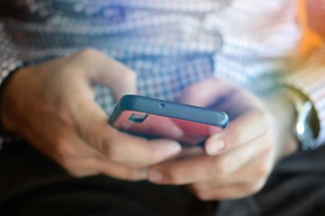 man typing on a smartphone,technology and addiction concept shallow dof