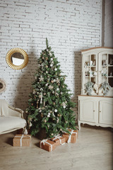 Vintage Christmas tree with red ball ornaments.home decoration with tree, gifts.Elegant christmas tree with decorations and gifts on elegant hardwood floor.New year and Happy Holidays.living room
