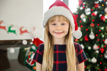 Young happy girl in santa hat smiling