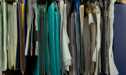 Top view on many folders with documents and office papers close-up, stock photo. Replacing paper workflow with electronic.