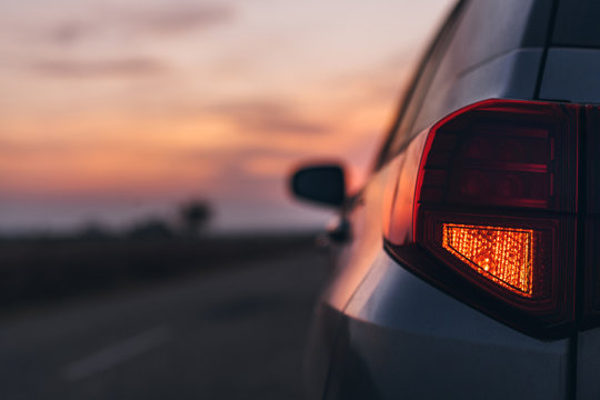 Car rear stop light in sunset, selective focus