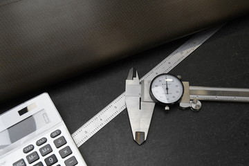 Calculator calipers and ruler used in quality assuarnce operations at business that need strict...