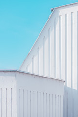 Urban abstract, white concrete wall against blue sky