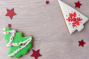 Christmas tree shaped cookies over wood background