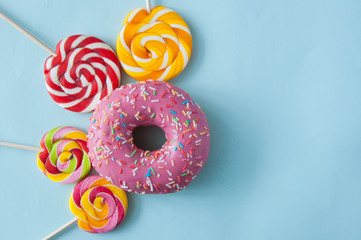 Colorful sweets. Lollipops and donuts. Top view with space for your text